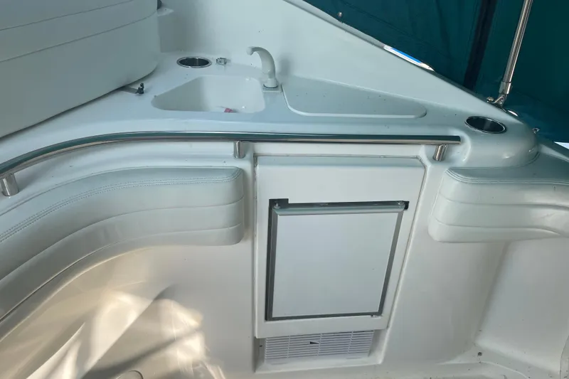Slide: The Image of 1999 Silverton 360 Express boat interior with sink, seating, and storage. - 13