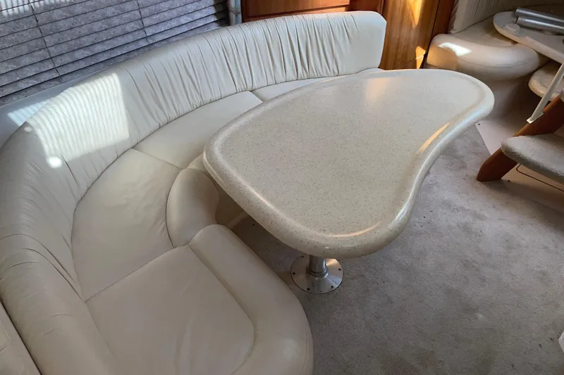 Slide: The Image of 1999 Silverton 360 Express interior with curved seating and unique table design. - 17