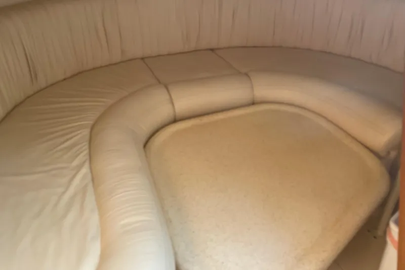 Slide: The Image of Interior seating area of a 1999 Silverton 360 Express boat with beige upholstery. - 18