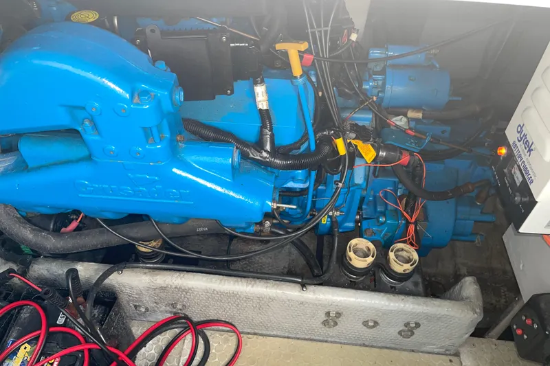 Slide: The Image of Engine compartment of a 1999 Silverton 360 Express with blue Crusader engine components. - 23