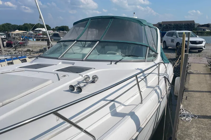 Slide: The Image of 1999 Silverton 360 Express yacht docked at marina under blue sky. - 3