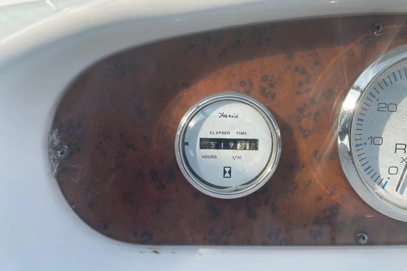 Slide: The Image of 1999 Silverton 360 Express boat dashboard with elapsed time gauge reading 519.6 hours. - 8