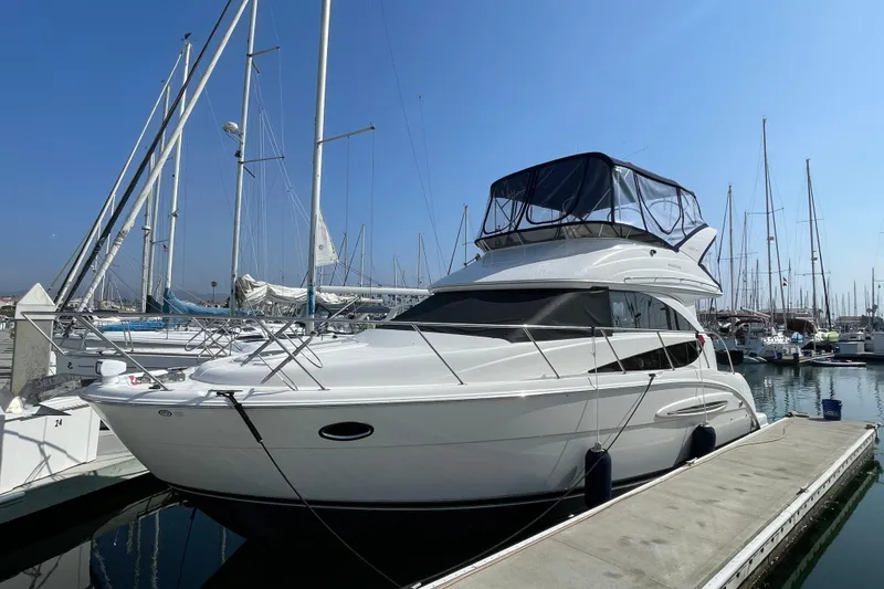 Slide: The Image of 2008 Meridian 341 Sedan yacht docked at marina under clear blue sky. - 0