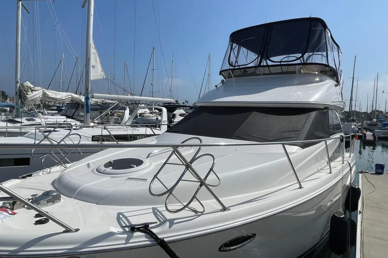 Slide: The Image of 2008 Meridian 341 Sedan yacht docked at marina, surrounded by sailboats under clear blue sky. - 1