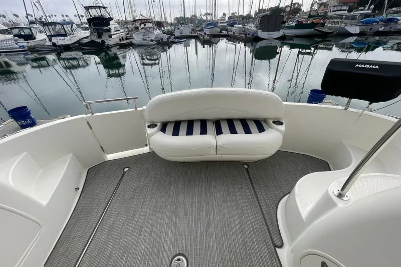 Slide: The Image of 2008 Meridian 341 Sedan yacht interior with striped seating in a marina setting. - 10