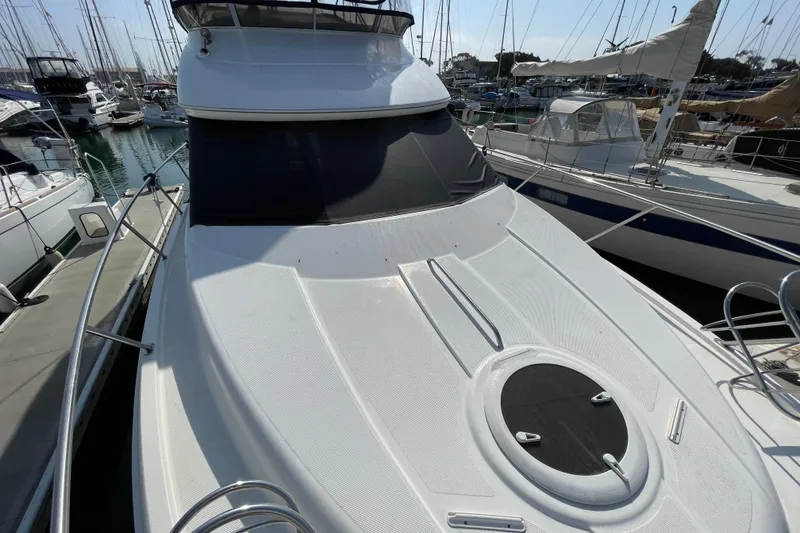 Slide: The Image of 2008 Meridian 341 Sedan yacht docked at marina, showcasing sleek design and spacious deck. - 12