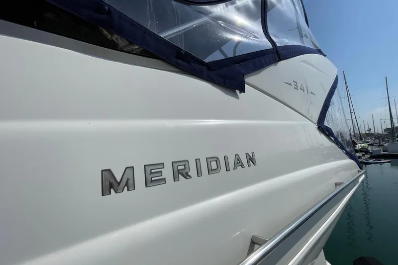 Slide: The Image of 2008 Meridian 341 Sedan yacht docked, showcasing sleek design and branding. - 15