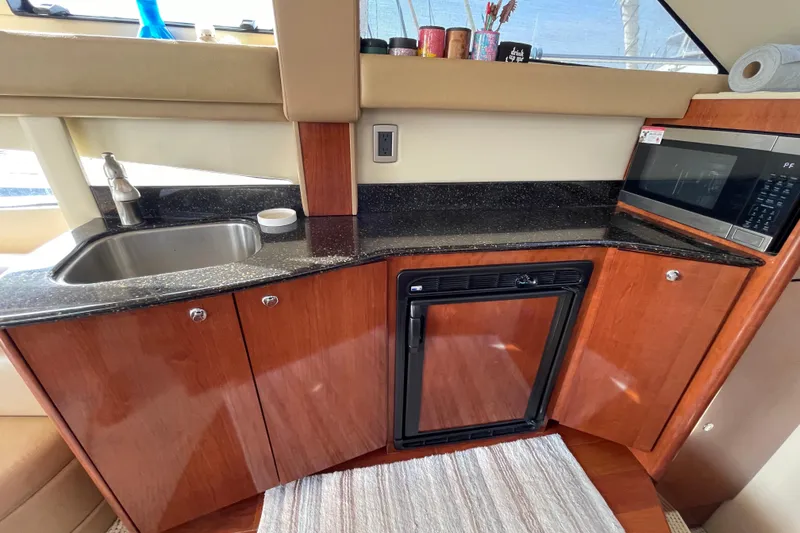 Slide: The Image of 2008 Meridian 341 Sedan yacht kitchen with sink, microwave, and mini-fridge. - 22