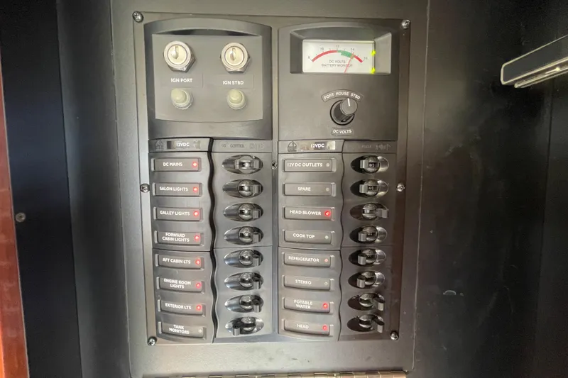 Slide: The Image of Electrical control panel of a 2008 Meridian 341 Sedan boat, featuring various switches and gauges. - 34
