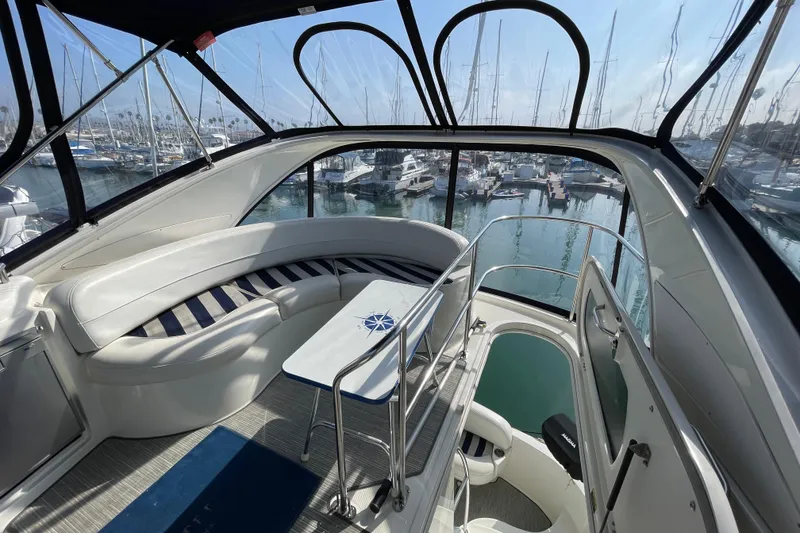 Slide: The Image of 2008 Meridian 341 Sedan yacht interior with marina view, featuring sleek seating and table. - 37