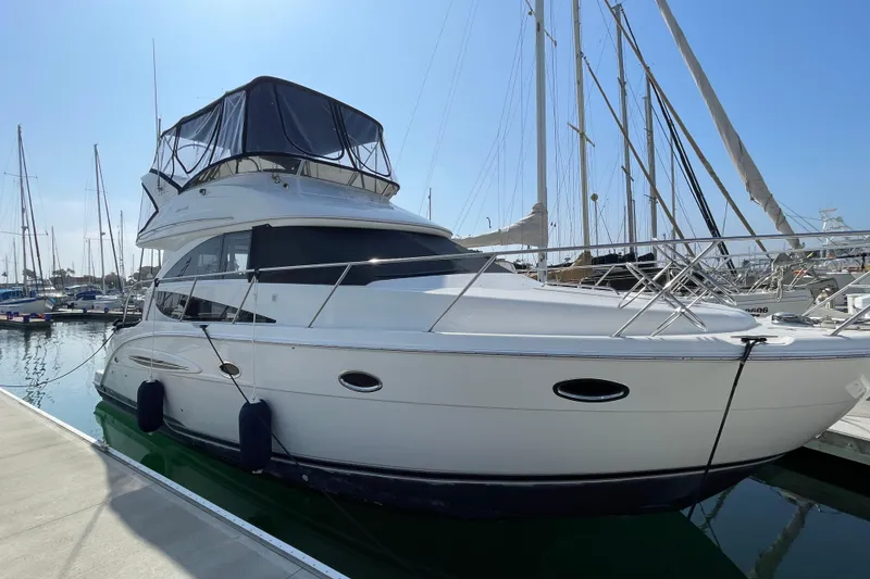 Slide: The Image of 2008 Meridian 341 Sedan yacht docked at marina under clear blue sky. - 4