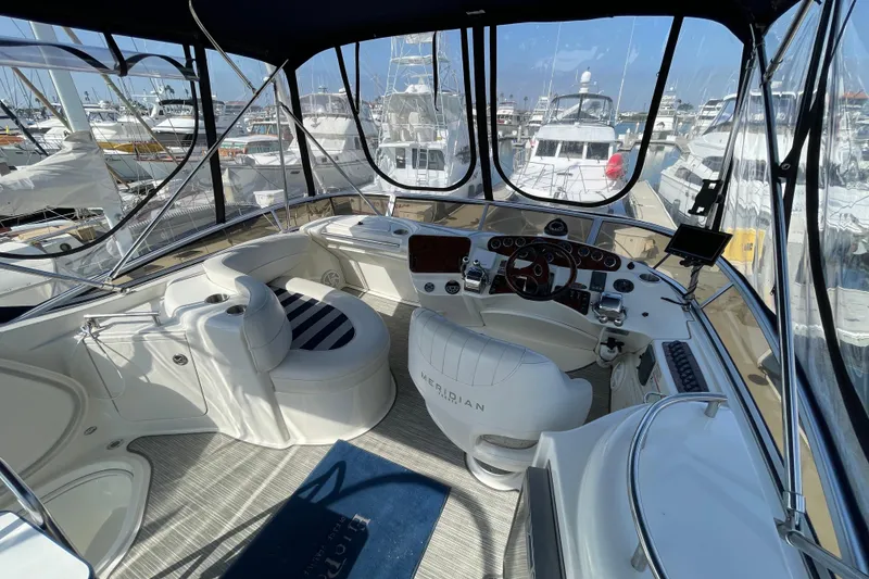 Slide: The Image of Luxurious 2008 Meridian 341 Sedan yacht interior with helm and seating area in marina. - 40