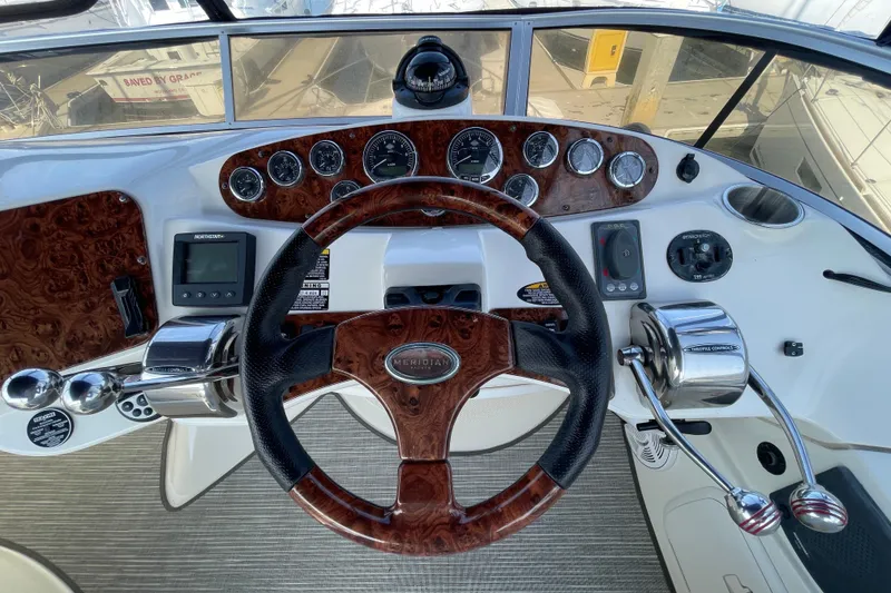 Slide: The Image of 2008 Meridian 341 Sedan helm with wood accents and modern controls. - 42