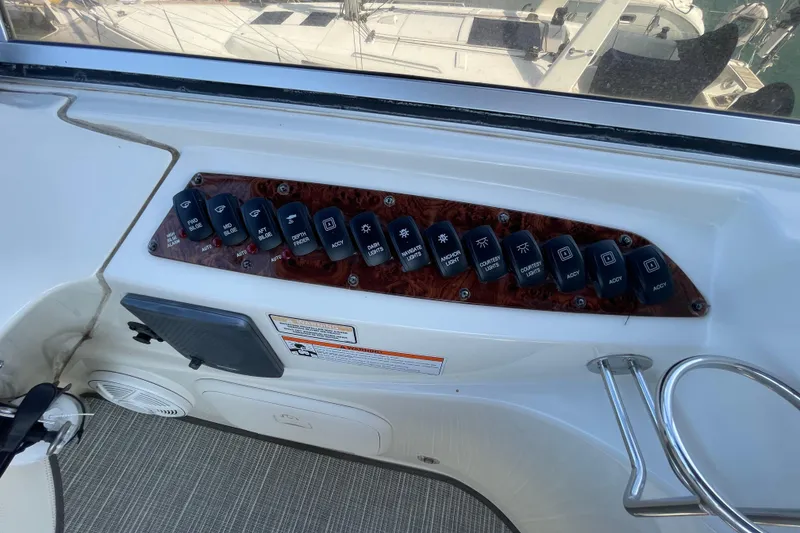 Slide: The Image of Control panel of a 2008 Meridian 341 Sedan boat with labeled switches. - 44