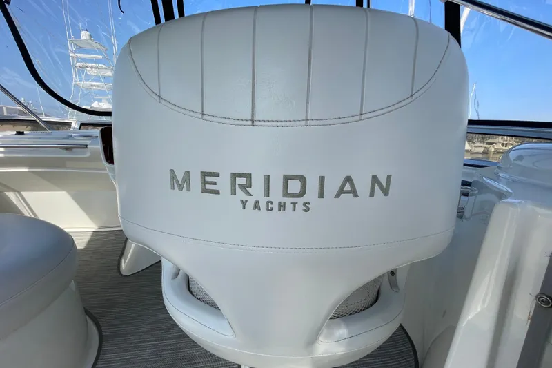 Slide: The Image of White captain's chair on 2008 Meridian 341 Sedan yacht, featuring "Meridian Yachts" logo. - 45