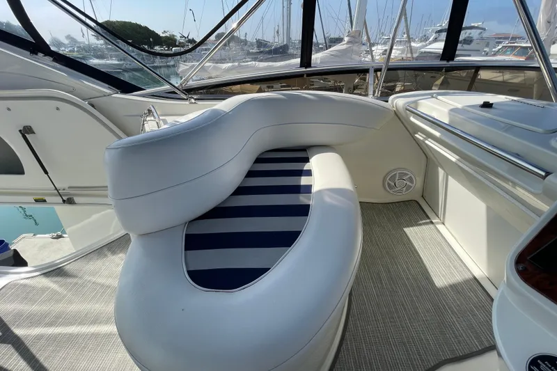 Slide: The Image of 2008 Meridian 341 Sedan yacht interior with curved seating and striped cushions. - 46