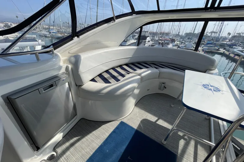 Slide: The Image of 2008 Meridian 341 Sedan interior with curved seating, table, and marina view. - 49
