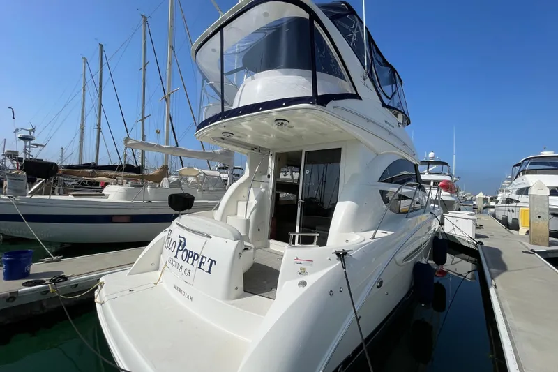 Slide: The Image of 2008 Meridian 341 Sedan yacht docked at marina under clear blue sky. - 6