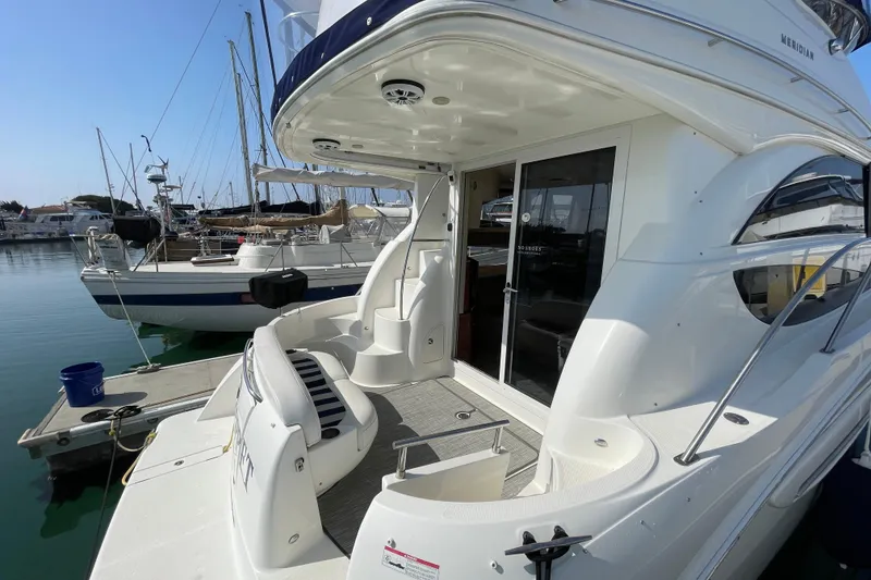 Slide: The Image of 2008 Meridian 341 Sedan yacht docked at marina, showcasing sleek design and spacious deck. - 7