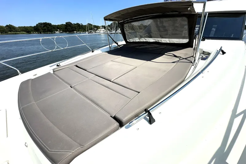 Slide: The Image of 2016 Prestige 550 yacht cruising on calm blue waters. - 11