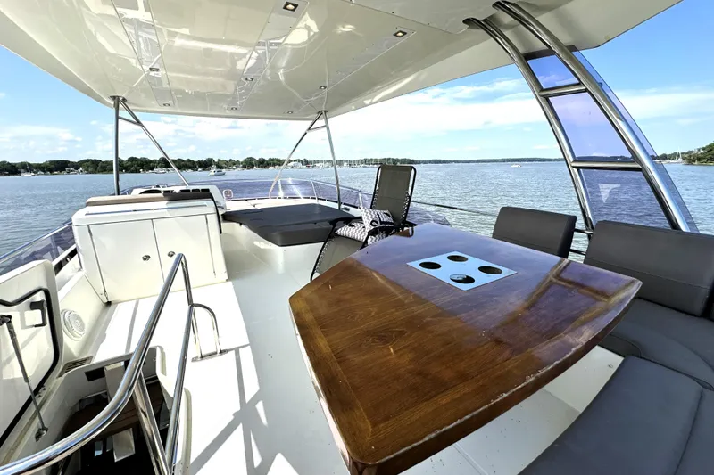 Slide: The Image of 2016 Prestige 550 yacht cruising on open water, aerial view. - 12