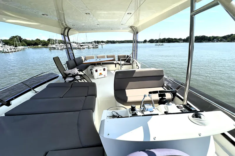 Slide: The Image of 2016 Prestige 550 yacht on calm water with cityscape background. - 13