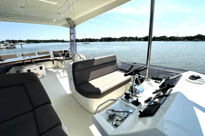 Slide: The Image of Luxury 2016 Prestige 550 yacht cruising in urban harbor setting. - 15