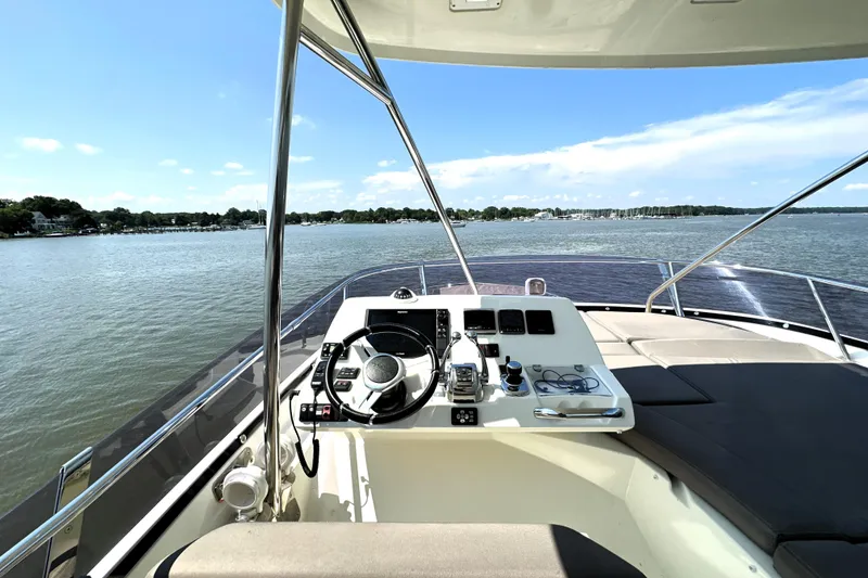 Slide: The Image of 2016 Prestige 550 yacht docked, featuring sleek design and spacious deck, Shady Side, MD. - 16