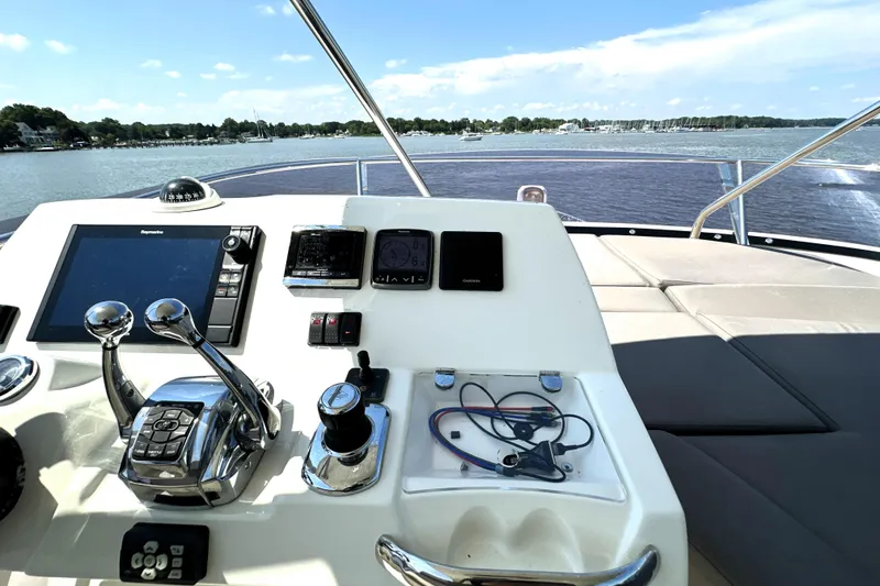 Slide: The Image of Luxury yacht Prestige 550, 2016 model, with elegant seating and table, docked at a marina. - 17