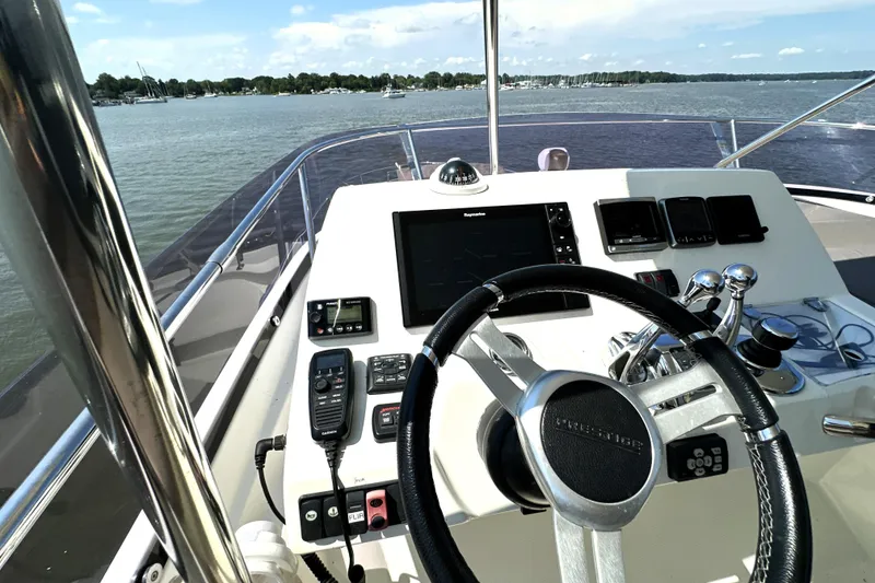Slide: The Image of Luxury yacht deck view, Prestige 550, 2016 model, overlooking marina with clear blue sky. - 18