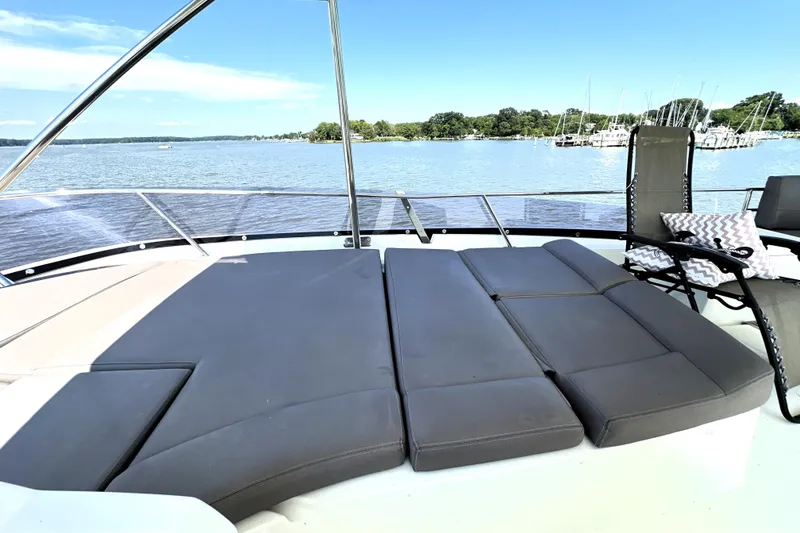 Slide: The Image of Luxurious 2016 Prestige 550 yacht docked at a scenic marina under a clear blue sky. - 19