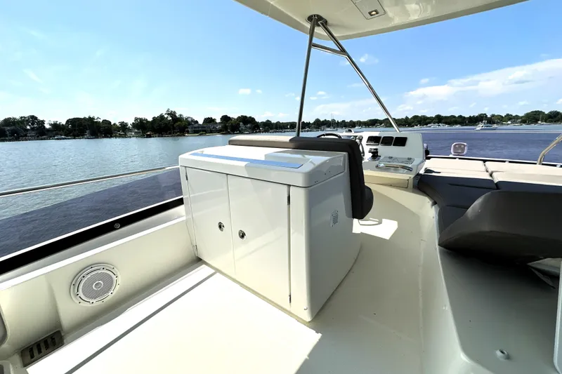 Slide: The Image of Prestige 550 yacht (2016) on water with city skyline in background. - 21