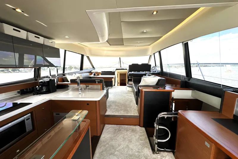 Slide: The Image of Bow of 2016 Prestige 550 yacht with ocean view and city skyline. - 24