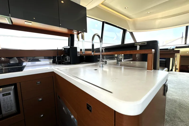 Slide: The Image of Luxurious 2016 Prestige 550 yacht with spacious deck and scenic marina view. - 27