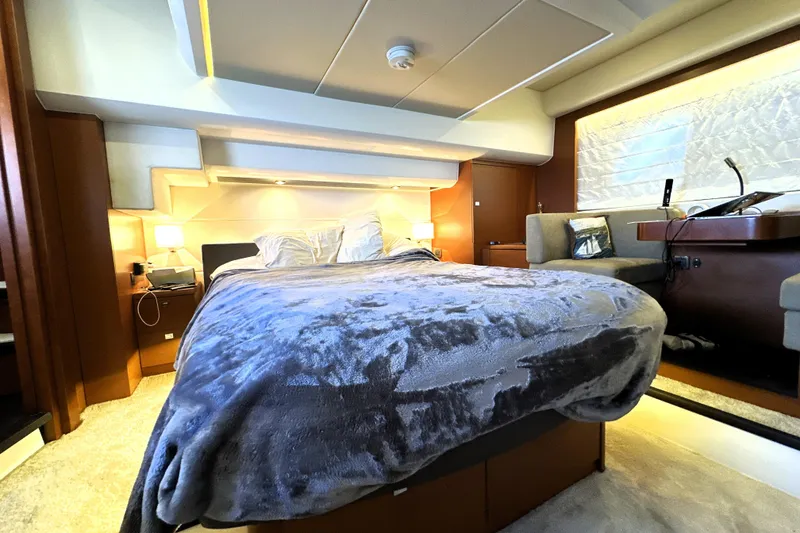 Slide: The Image of Luxurious cabin interior of 2016 Prestige 550 yacht with elegant bedding and ambient lighting. - 3
