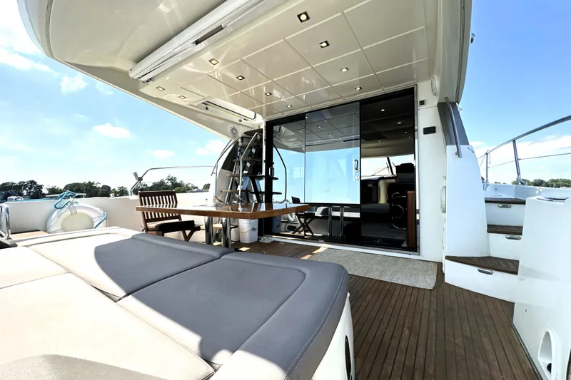 Slide: The Image of Luxurious 2016 Prestige 550 yacht on calm water under clear blue sky. - 5