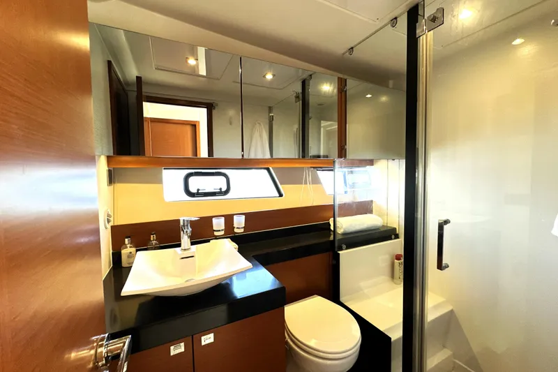 Slide: The Image of Cockpit view of a 2016 Prestige 550 yacht with navigation controls and sea in background. - 51