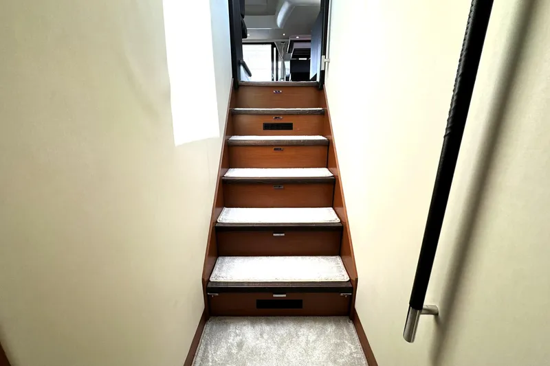 Slide: The Image of Close-up of a 2016 Prestige 550 tachometer showing 27.1 volts and 889 hours. - 52