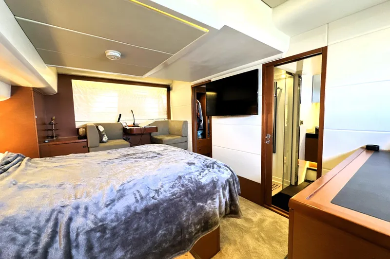 Slide: The Image of Luxurious cabin interior of 2016 Prestige 550 yacht with elegant bedding and ambient lighting. - 55