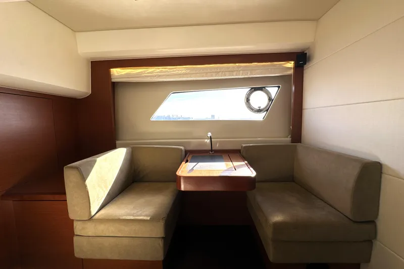 Slide: The Image of Luxurious interior of 2016 Prestige 550 yacht with cozy seating and window view. - 68