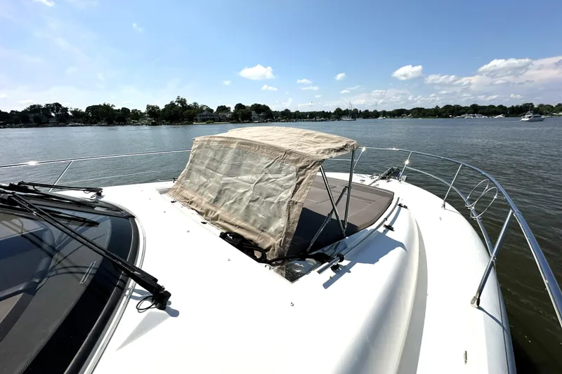 Slide: The Image of 2016 Prestige 550 yacht cruising in a marina with cityscape background. - 9