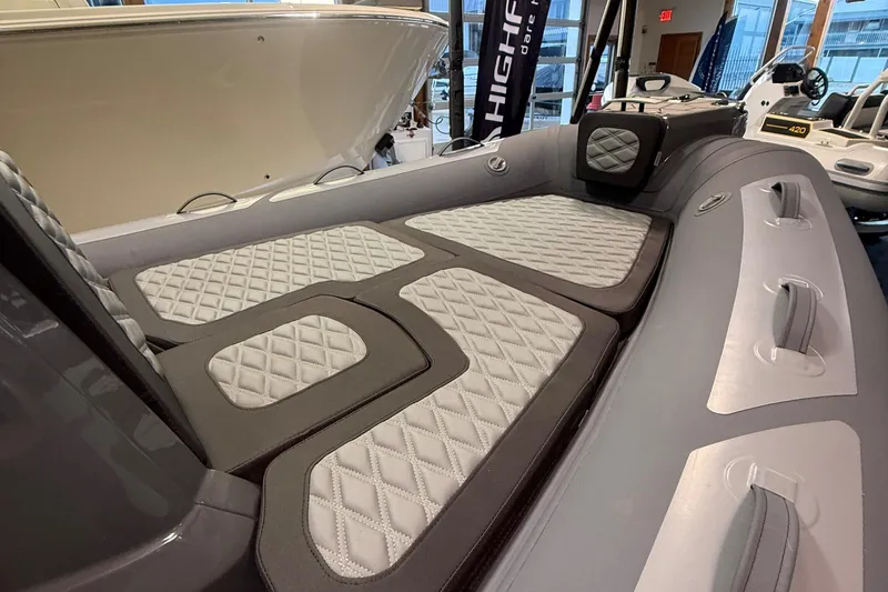 Slide: The Image of 2026 Highfield Sport 560 boat interior with quilted seating and modern design. - 9