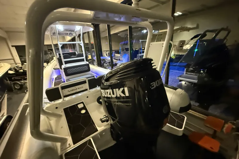 Slide: The Image of 2026 Highfield Sport 760 boat with Suzuki 300 outboard engine in showroom. - 11