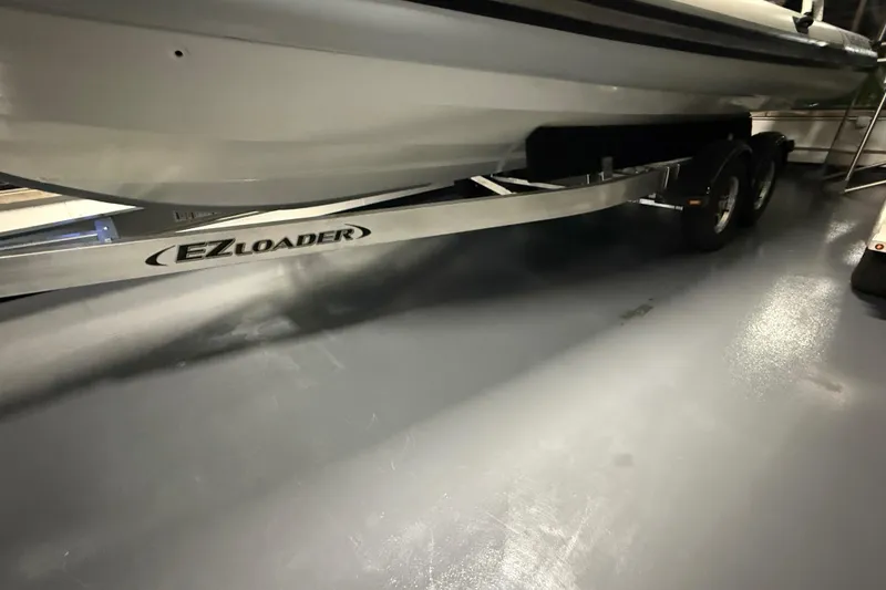 Slide: The Image of 2026 Highfield Sport 760 boat on EZ Loader trailer in a showroom. - 14