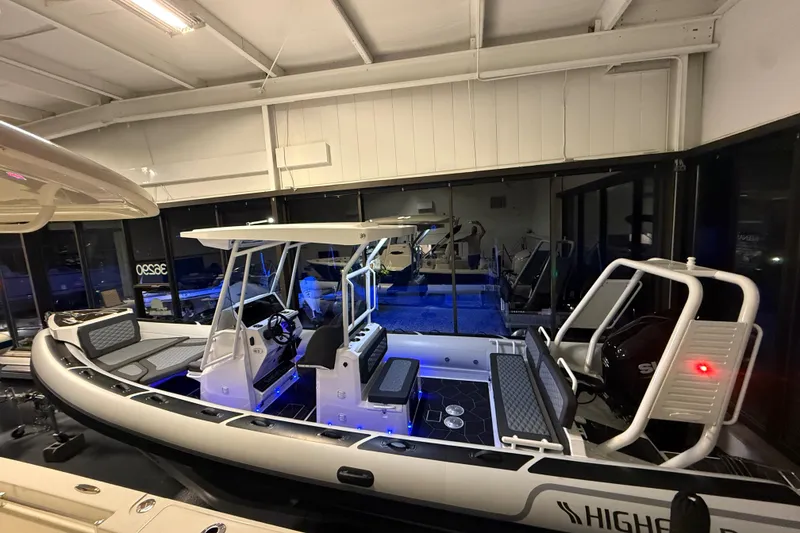 Slide: The Image of 2026 Highfield Sport 760 boat in showroom, featuring modern design and seating. - 9