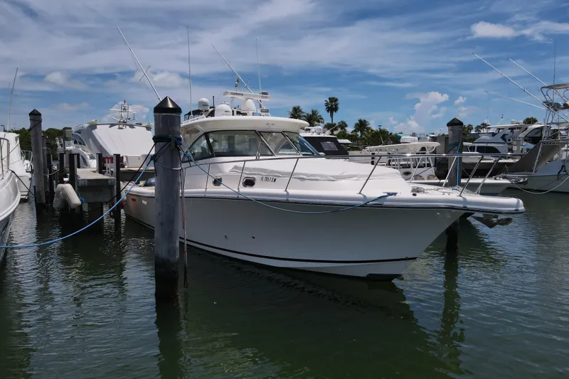 Slide: The Image of 2010 Pursuit OS 375 Offshore boat docked at marina under blue sky. - 10