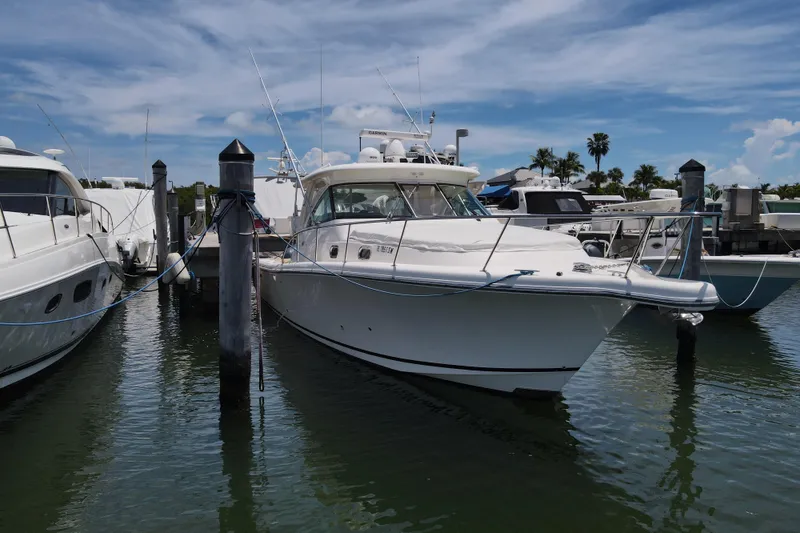 Slide: The Image of 2010 Pursuit OS 375 Offshore boat docked at marina under blue sky. - 11