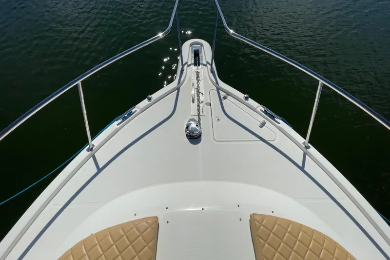 Slide: The Image of Bow view of 2010 Pursuit OS 375 Offshore boat on water. - 17