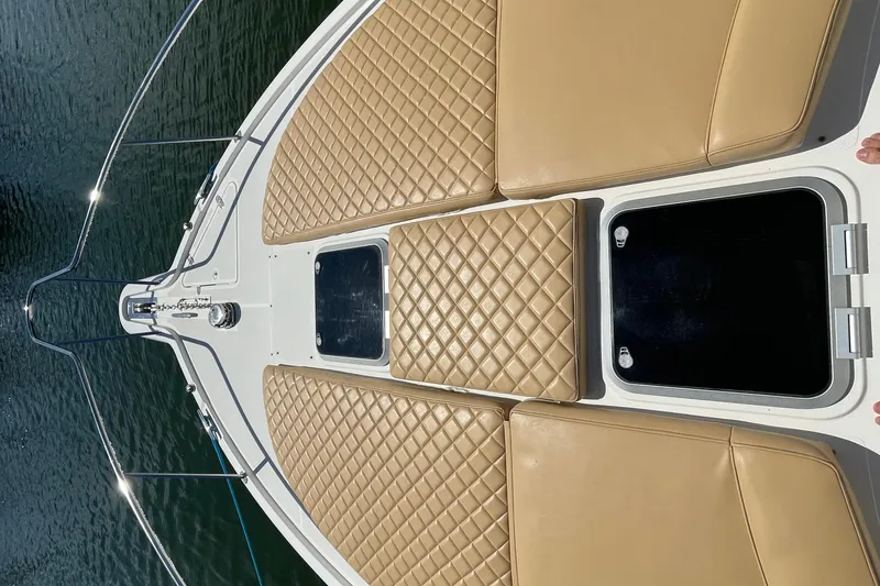 Slide: The Image of 2010 Pursuit OS 375 Offshore boat with tan cushioned deck, viewed from above. - 20