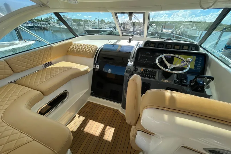 Slide: The Image of Luxurious interior of 2010 Pursuit OS 375 Offshore boat with leather seating and modern dashboard. - 24